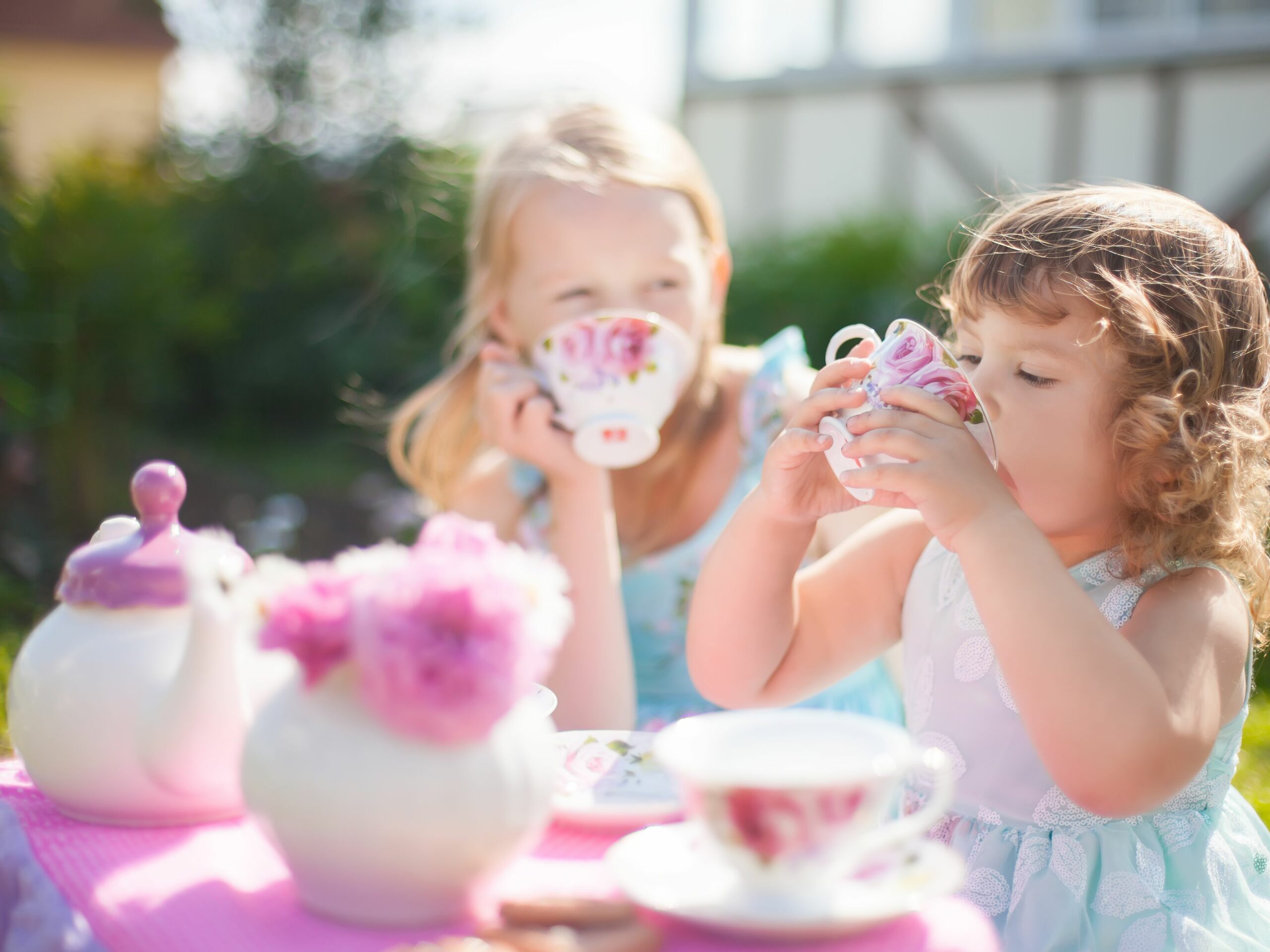 two sisters playing tea party outdoors 869842326 ae6f64a51daa4f79aaf6e140be32314b scaled - The Playroom