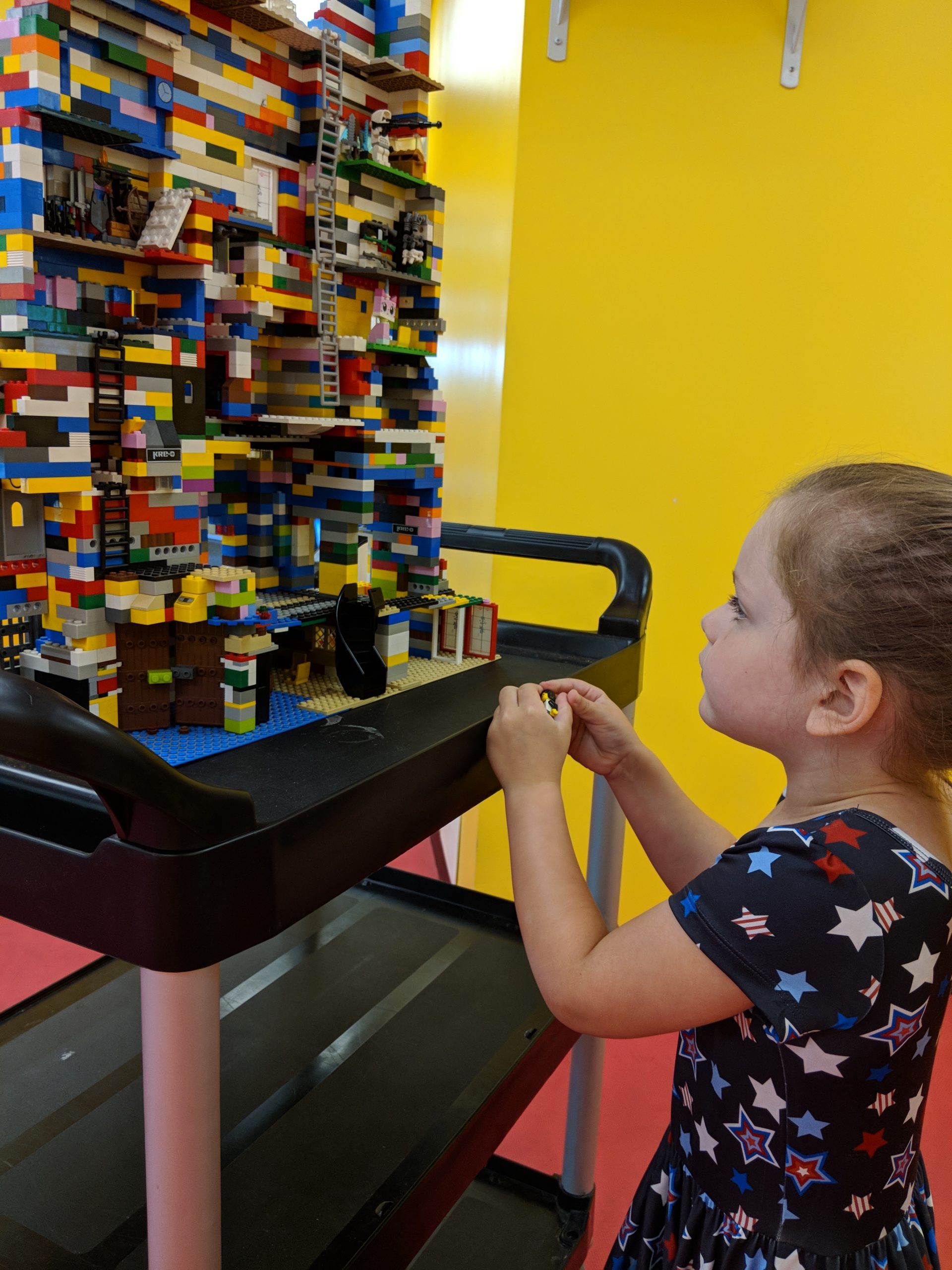 Girl admires Lego creation during Fun Fridays at The Playroom in Harford County, MD